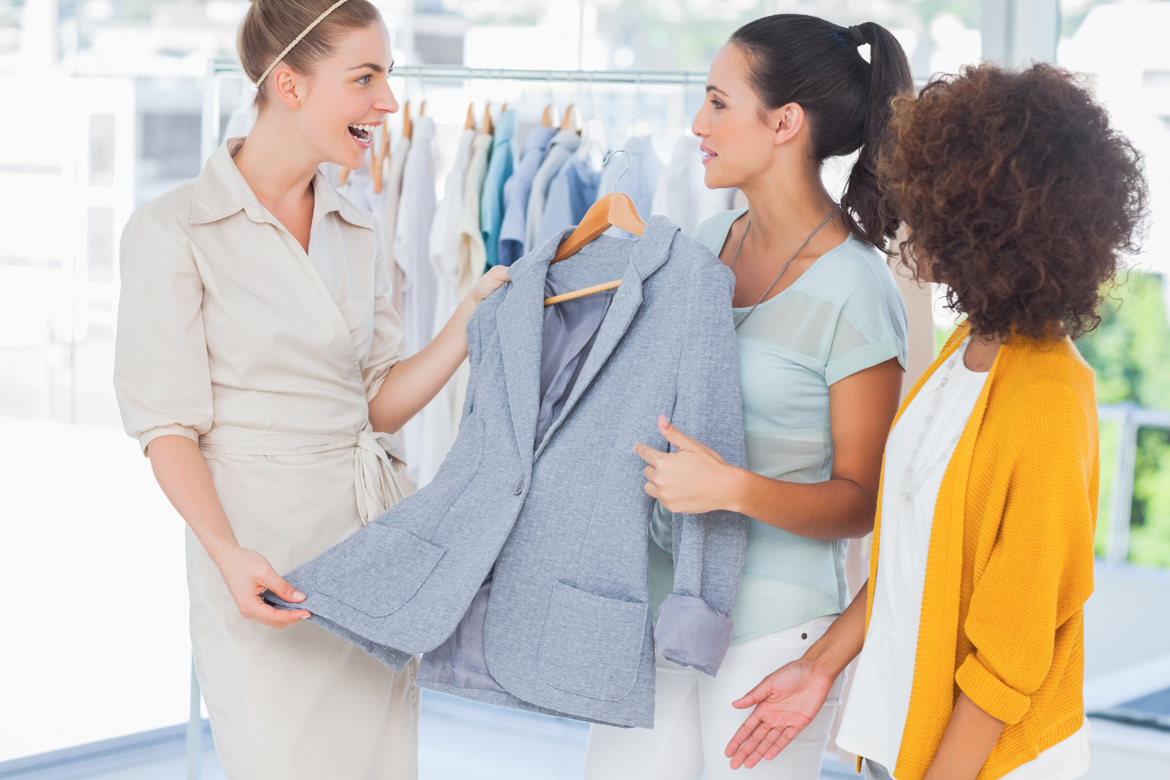 Smiling women holding a blazer